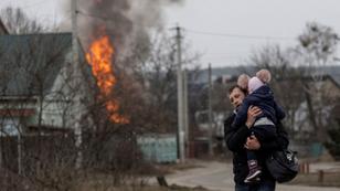 Residents flee from the town of Irpin, Ukraine, after heavy shelling by Russia destroyed the only escape route used by locals, March 6, 2022, photo by Carlos Barria/Reuters